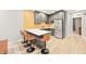 Modern kitchen with sleek gray cabinets, stainless steel appliances, and breakfast bar at 15547 W Vassar Ave, Lakewood, CO 80228