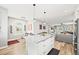 Open concept kitchen with granite island, stainless steel appliances and spacious eating area at 15547 W Vassar Ave, Lakewood, CO 80228