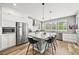 Modern kitchen features a center island, stainless appliances, and beautiful tile backsplash at 15547 W Vassar Ave, Lakewood, CO 80228
