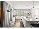 Modern kitchen with stainless steel appliances, white cabinets, and a large kitchen island at 15547 W Vassar Ave, Lakewood, CO 80228