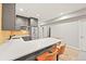 Modern kitchen featuring island with seating and stainless steel appliances at 15547 W Vassar Ave, Lakewood, CO 80228