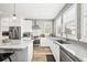 Bright kitchen with stainless steel appliances, updated finishes, an island, and plenty of counter space at 15547 W Vassar Ave, Lakewood, CO 80228