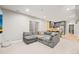 Comfortable living room with large sectional sofa, carpet, and view of the kitchen at 15547 W Vassar Ave, Lakewood, CO 80228