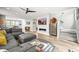 Bright living room boasting a fireplace, media center, and staircase to the second floor at 15547 W Vassar Ave, Lakewood, CO 80228