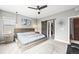 Bright main bedroom with contemporary decor including ceiling fan, light fixture, and outside access at 15547 W Vassar Ave, Lakewood, CO 80228