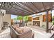 Outdoor living area features a fireplace, tv, pergola, and hot tub at 15547 W Vassar Ave, Lakewood, CO 80228