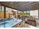 Covered patio includes a hot tub and outdoor furniture at 15547 W Vassar Ave, Lakewood, CO 80228