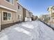 View of snow covered apartment complex back yard at 5888 Biscay St # D, Denver, CO 80249