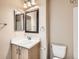 Bright bathroom vanity with mirror and cabinet at 5888 Biscay St # D, Denver, CO 80249