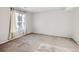 Sunny bedroom with window and neutral carpet at 5888 Biscay St # D, Denver, CO 80249
