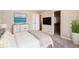 Well-lit bedroom with a modern closet and blue wall art at 5888 Biscay St # D, Denver, CO 80249
