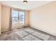 The sun-filled bedroom boasts a large window and neutral carpeting and walls at 5888 Biscay St # D, Denver, CO 80249