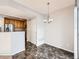 Bright dining space adjacent to kitchen features hard flooring and modern lighting at 5888 Biscay St # D, Denver, CO 80249