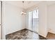Dining area features sliding glass door, modern light fixture, and hard flooring at 5888 Biscay St # D, Denver, CO 80249