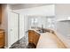 A modern kitchen features stainless sink, neutral countertop, and pantry at 5888 Biscay St # D, Denver, CO 80249