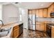 Updated kitchen features stainless steel appliances and stylish flooring at 5888 Biscay St # D, Denver, CO 80249