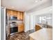 Bright kitchen features stainless appliances, light wood cabinetry, and durable flooring at 5888 Biscay St # D, Denver, CO 80249