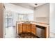 Eat in kitchen includes modern cabinets, sleek stainless dishwasher, and double sink at 5888 Biscay St # D, Denver, CO 80249