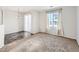 Open-concept living room with large window and sliding glass doors at 5888 Biscay St # D, Denver, CO 80249
