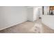 Bright living room with carpet, view to the stairs and kitchen at 5888 Biscay St # D, Denver, CO 80249