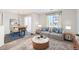 Comfortable living room with large window, a sofa, and a dining area at 5888 Biscay St # D, Denver, CO 80249