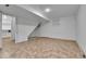 Unfinished basement with tile floor, white walls, and access to utility room at 21455 E 44Th Ave, Denver, CO 80249