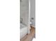 Bathroom featuring tub, toilet, shower head and wood flooring at 21455 E 44Th Ave, Denver, CO 80249