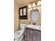 Cozy bathroom with vanity, mirror, toilet, and granite counter at 21455 E 44Th Ave, Denver, CO 80249