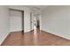Empty bedroom with closet and doorway, featuring hardwood flooring and white walls at 21455 E 44Th Ave, Denver, CO 80249