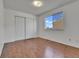 Bedroom featuring hardwood flooring, closet, and window with natural light at 21455 E 44Th Ave, Denver, CO 80249