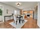 Open floor plan with kitchen view from the dining room, features stylish furniture, and tile flooring at 21455 E 44Th Ave, Denver, CO 80249
