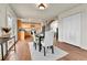 Bright dining room with backyard access, tile flooring, stylish furniture, and seamless transition to the kitchen at 21455 E 44Th Ave, Denver, CO 80249