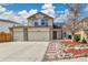 Two-story home featuring a three car garage, neat landscaping, and mature trees at 21455 E 44Th Ave, Denver, CO 80249