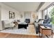 Cozy living room with a stone fireplace, hardwood floors, neutral color palette, and modern furniture at 21455 E 44Th Ave, Denver, CO 80249
