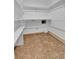 Walk-in closet with shelving, white walls, and vinyl flooring at 21455 E 44Th Ave, Denver, CO 80249