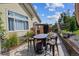 Backyard patio features an outdoor table and chairs, perfect for enjoying meals outside at 4293 Clover Ln, Brighton, CO 80601