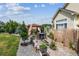This backyard oasis boasts an outdoor dining area and lush landscaping at 4293 Clover Ln, Brighton, CO 80601