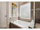 Bright bathtub featuring tile backsplash, a frosted window and decor accents at 4293 Clover Ln, Brighton, CO 80601