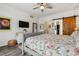 Beautiful bedroom with a floral comforter and wood sliding barn door to the walk-in closet at 4293 Clover Ln, Brighton, CO 80601