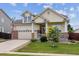 Charming two-story home featuring a welcoming porch, well-manicured lawn, and an attached two-car garage at 4293 Clover Ln, Brighton, CO 80601
