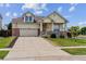 Inviting two-story home with a cozy front porch, green lawn, and a spacious driveway leading to a two-car garage at 4293 Clover Ln, Brighton, CO 80601