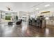 Spacious open-concept kitchen and living area with hardwood floors and stylish furniture at 4293 Clover Ln, Brighton, CO 80601