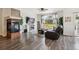 Cozy living room with hardwood floors, fireplace, a large window, and comfortable leather seating at 4293 Clover Ln, Brighton, CO 80601