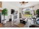 Cozy living room with hardwood floors, fireplace, a large window, and comfortable leather seating at 4293 Clover Ln, Brighton, CO 80601