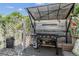 Covered outdoor kitchen area featuring a grill, prep station, and outdoor seating at 4293 Clover Ln, Brighton, CO 80601