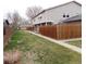 A spacious backyard features a lush green lawn and a tall wood fence, perfect for outdoor entertaining at 1015 Alta St, Longmont, CO 80501