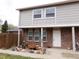 Charming townhome features a brick facade, a white front door, and a landscaped garden at 1015 Alta St, Longmont, CO 80501