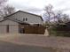 This townhome features a two-car garage and a wooden fence, providing both convenience and privacy at 1015 Alta St, Longmont, CO 80501