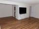 A bright living room with wood floors leads to the kitchen area and offers an entertainment space at 1015 Alta St, Longmont, CO 80501