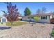 Well maintained backyard with rock garden, lawn, shed, and a charming single-story home at 3195 S Kalispell Ct, Aurora, CO 80013